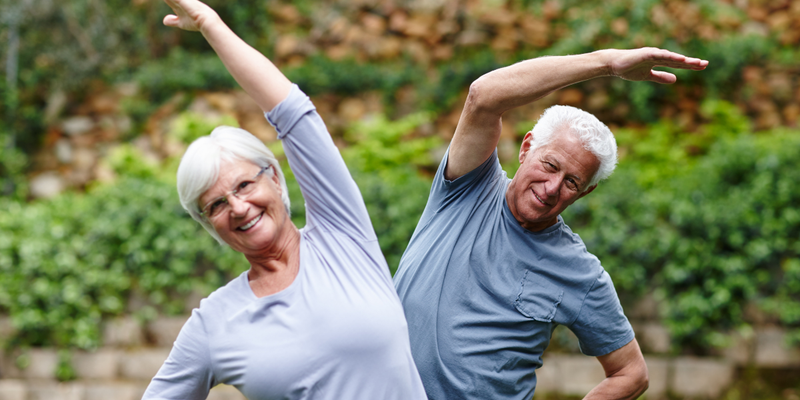 Older man and older women stretching.