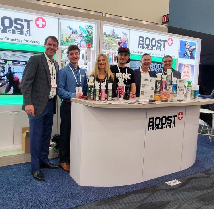 Various Boost Oxygen team members at their trade show booth.