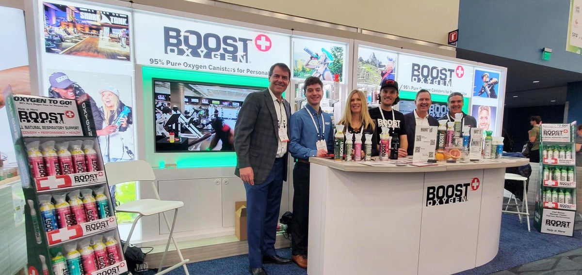 Various Boost Oxygen team members at their trade show booth.