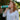 Woman outside near trees using Boost Oxygen Breathe.