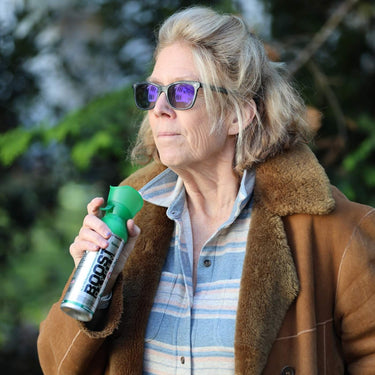Older woman getting ready to use a can of Boost Oxygen.