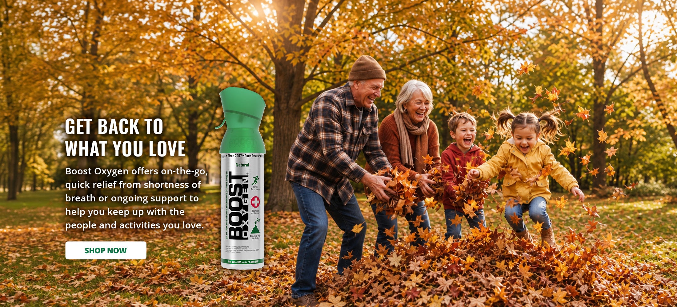 A family playing in fallen autumn leaves outdoors, with a Boost Oxygen Natural can shown in the lower right on a dark green promotional background with text saying 