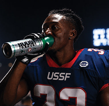 Football player is in a stadium under the lights using Boost Oxygen.